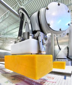 cobot moving large block of cheese